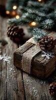 Rustic holiday gift with natural decorations on wooden surface, surrounded by pine cones and evergreen branches photo