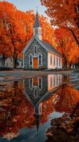 Beautiful autumn landscape featuring a historic stone church in vibrant fall colors reflecting in water photo