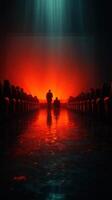 Audience members watch a dramatic presentation in a dark theater illuminated by red light photo