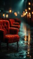 Cozy red chairs on a rainy night in an urban alley illuminated by soft lights photo