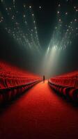 Empty theater with bright lights illuminating red seats and a solitary figure standing in the center photo