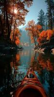 Kayaking through vibrant autumn trees by the calm river in the early morning light photo