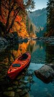 Serene autumn kayak excursion on a tranquil river surrounded by vibrant foliage and mountain reflections photo