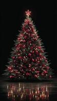 Beautifully decorated Christmas tree shining with red ornaments and lights against a dark background during the holiday season photo