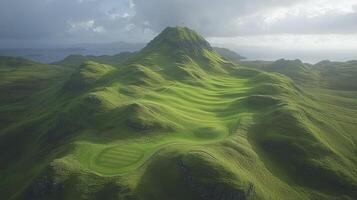 A green golf course with mountains in the background photo