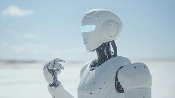 A robot standing in the snow with his hands up photo