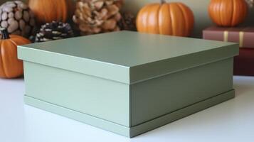 A green box sitting on a table with pumpkins photo