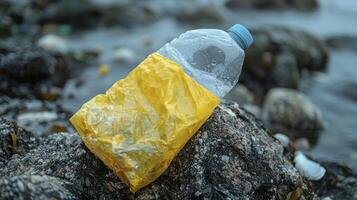 A plastic bottle on a rock by the ocean photo