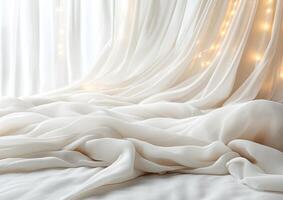 Soft white fabric draped on bed near window with lights photo