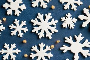 Festive snowflake pattern on dark blue background photo