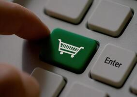Finger presses online shopping button photo