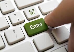 A person is pressing enter on a green button on a keyboard photo