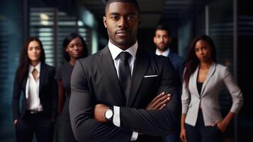 A group of business people standing in front of a man in a suit photo