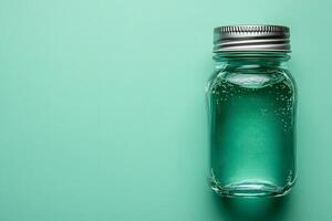 Minimalist Aesthetic Glass Jar on Aqua Background for Design and Branding photo