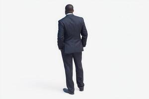 A man in a well-fitted dark suit stands with his back to the viewer in a simplistic background. He exudes professionalism and confidence, showcasing a modern business style. photo
