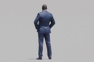 A businessman dressed in a tailored blue suit stands with his back facing the viewer, exhibiting a confident posture. The plain background emphasizes his presence and professionalism. photo