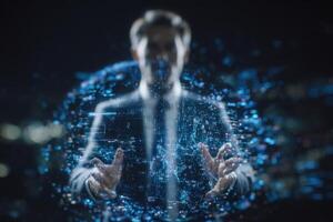 A man in a suit stands in a dark environment, reaching out with his hands towards a glowing digital sphere. Light particles surround him, hinting at advanced technology and innovation. photo