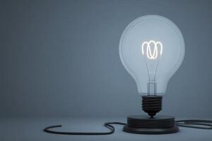 A vintage light bulb with an intricate filament design illuminates a dimly lit space. The bulb rests on a simple black base, casting soft light that enhances the serene atmosphere. photo