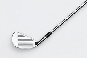 Close-up view of a golf club featuring a polished chrome surface and detailed grooves on the clubface, emphasizing its craftsmanship and suitability for gameplay during a clear day on the course. photo