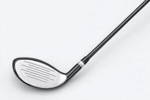Close-up view of a golf club head, showcasing its sleek design. The shiny surface contrasts with the black color of the shaft, emphasizing the grooves for improved performance during play. photo