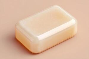 A pale beige soap bar rests on a smooth surface, embodying a sleek and modern design. The soft lighting enhances the gentle shine of the bar, emphasizing its purity and simplicity. photo