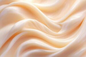 This soft cream-colored fabric displays smooth waves and folds that gently flow, creating a calming and elegant atmosphere. The delicate texture enhances its luxurious appearance. photo