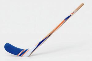 A hockey stick features a vibrant blue and orange design. The curved blade is prominently showcased, while the handle maintains a natural wood finish, highlighting details of the craftsmanship. photo