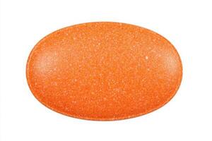 A smooth, bright orange tablet is centered on a white background. Its oval shape and glossy surface catch the light, highlighting its uniform color and texture. photo