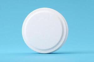A plain white circular object is centered against a vibrant blue background, emphasizing its smooth texture and minimalist design. Ideal for showcasing simplicity in decoration or product display. photo