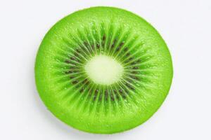 A sliced kiwi reveals its bright green interior and distinctive pattern of seeds. The fruit is presented on a neutral backdrop, highlighting its fresh and juicy appearance. photo