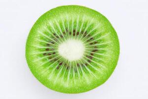 This close-up view features a sliced kiwi displaying its bright green flesh, textured seeds, and radiating pattern. The natural beauty of the fruit highlights its freshness and juiciness. photo