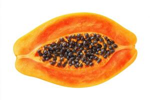 A halved papaya displays its bright orange flesh and numerous black seeds nestled in the middle. The fruit is presented on a plain white background, emphasizing its natural colors. photo
