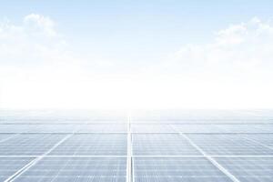 An array of solar panels spans across a vast area under a clear blue sky. Sunlight reflects off the panels, showcasing their role in sustainable energy production. photo