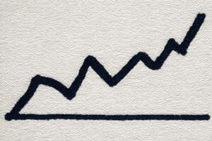 A black zigzag line rises sharply on a light background, representing increasing values over a period. This visual signifies growth and positive progress, capturing business success. photo