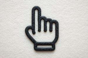 A textured surface features a black hand gesture symbol, specifically an index finger pointing upwards, indicating stop or attention. The design emphasizes simplicity and clarity. photo