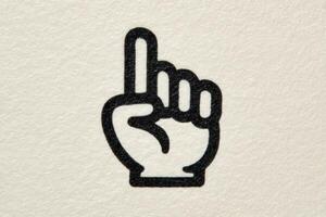 A hand with one finger raised, conveying a gesture of asking for attention or indicating that someone has something important to say. The simple design emphasizes clarity. photo