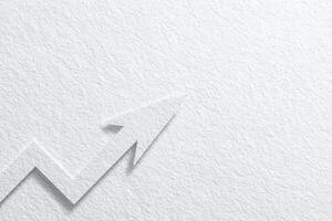 A simple upward arrow made of paper is shown against a textured white background. This design symbolizes growth, progress, and positive trends in business or finance, ideal for presentations. photo