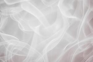 Delicate white smoke gracefully swirls and intertwines, creating a soft, ethereal atmosphere against a subtle light backdrop. This gentle movement evokes a feeling of calm and tranquility. photo