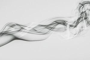 Delicate wisps of smoke flow gracefully, creating intricate patterns in the air. The tranquil movement conveys a sense of calm, with a light gray hue contrasting the bright background. photo
