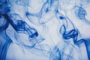 A mesmerizing display of blue smoke gracefully swirls across a light background, forming intricate, flowing patterns. The ethereal shapes blend seamlessly, creating an artistic composition. photo