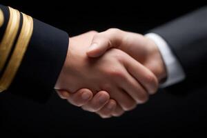 Two hands clasp in a handshake, symbolizing a partnership or agreement. One hand belongs to a person in formal attire, while the other shows a military uniform, indicating collaboration. photo