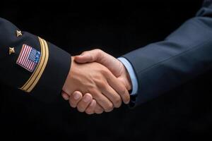 Two individuals engage in a firm handshake, symbolizing cooperation and mutual respect. One is dressed in military attire with a flag insignia, while the other is in formal civilian clothing. photo