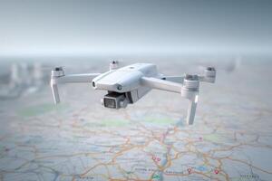 A white drone hovers above a map, capturing a clear view of urban locations and geographical features. The aerial perspective highlights various points of interest and landmarks. photo