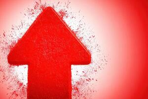 A strong red arrow stands prominently against a vibrant backdrop, emphasizing movement and positive growth. The splatter effect enhances the dynamic feel of the composition. photo