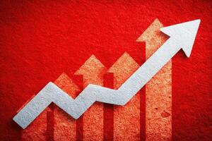A visually striking graph with a series of ascending bars and a sharp arrow indicates significant growth over time. The background is vibrant red, enhancing the sense of achievement and progress. photo
