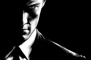 A man in a dark suit stands partially in shadow, showcasing a serious expression. The focus is on his intense eyes and sharp facial features, creating an air of mystery. photo