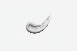 A smooth and flowing gray paint stroke is displayed on a pristine white background, emphasizing the elegance of simplicity and artistic design. Its fluid shape suggests movement and creativity. photo