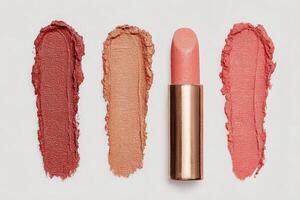 Three different lip colors are displayed with a lipstick in the center. The shades range from deep red to soft pink, showcasing a variety of textures and finishes, highlighting beauty options. photo