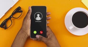 Close up Top View Of Black Female Hand Holding Phone With Incoming Call From Unknown Caller photo