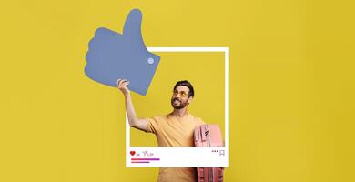 An enthusiastic influencer is smiling while holding a large thumbs-up symbol. He stands in front of a vibrant yellow backdrop, showcasing excitement for social media interactions. photo